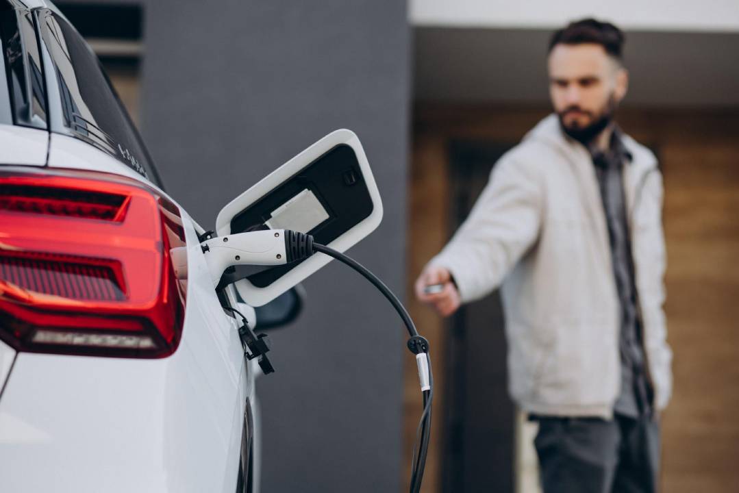 1 man is charging a car with a 7kW home charger